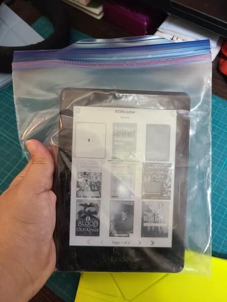 The Kindle Voyage in a plastic Ziploc bag